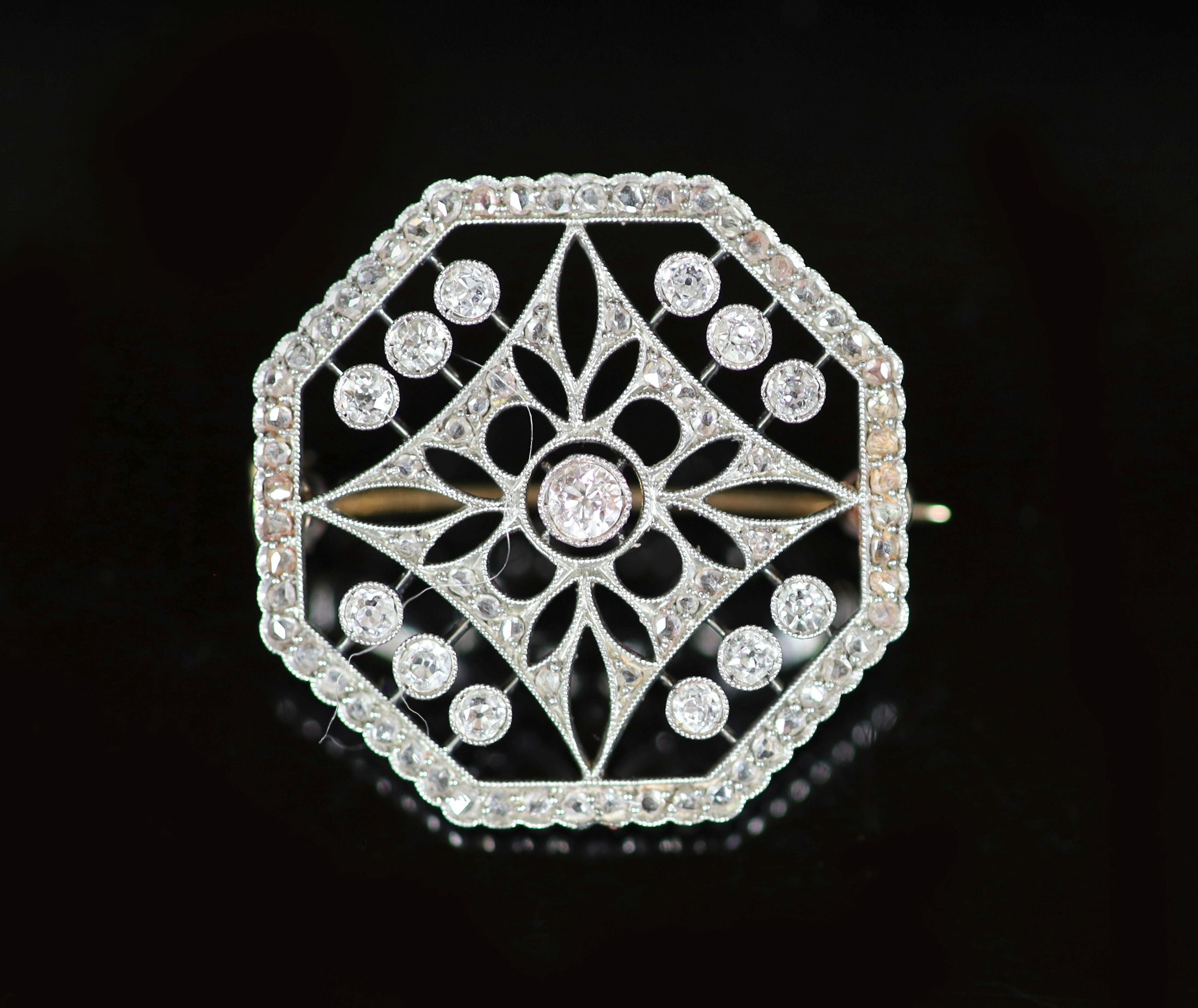 A Belle Epoque platinum, round and rose cut diamond millegrain set octagonal open work brooch